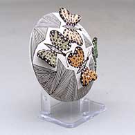 A polychrome seed pot decorated with butterfly wing appliques and a butterfly, fineline and geometric design, click or tap to see a larger version