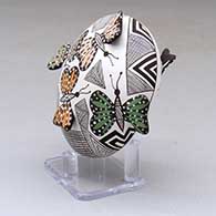 A polychrome seed pot decorated with butterfly wing appliques and a butterfly, fineline and geometric design, click or tap to see a larger version
