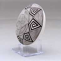 A black on white seed pot decorated with a butterfly wing applique and a butterfly, fineline and geometric design, click or tap to see a larger version