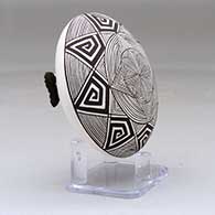 A black on white seed pot decorated with a butterfly wing applique and a butterfly, fineline and geometric design, click or tap to see a larger version