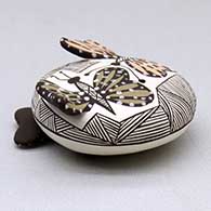 A miniature polychrome seed pot decorated with butterfly wing appliques and a butterfly, fineline and geometric design, click or tap to see a larger version