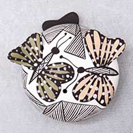 A miniature polychrome seed pot decorated with butterfly wing appliques and a butterfly, fineline and geometric design
 by Alisha Sanchez of Acoma