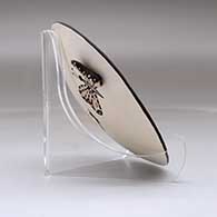 A small polychrome plate decorated with butterfly wing appliques and a butterfly, fineline and geometric design, click or tap to see a larger version