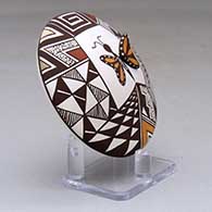 A polychrome seed pot decorated with butterfly wing and lady bug appliques and a butterfly, fineline and geometric design, click or tap to see a larger version