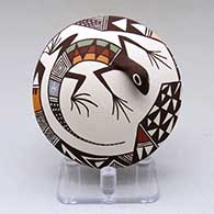 A polychrome seed pot decorated with lizard head and tail appliques and a geometric design
 by Carolyn Concho of Acoma