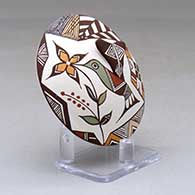 A polychrome seed pot decorated with hummingbird wing and lady bug appliques and a hummingbird, flower and geometric design, click or tap to see a larger version