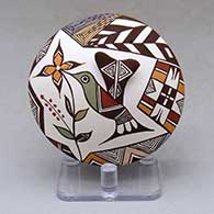 A polychrome seed pot decorated with hummingbird wing and lady bug appliques and a hummingbird, flower and geometric design
 by Carolyn Concho of Acoma