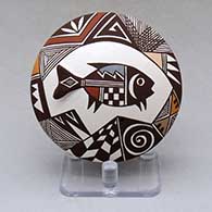 A polychrome seed pot decorated with fish tail and lady bug appliques and a Mimbres fish, fineline, spiral and geometric design
 by Carolyn Concho of Acoma