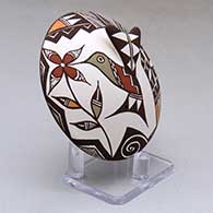 A polychrome seed pot decorated with hummingbird wing and lady bug appliques and a hummingbird, flower, spiral and geometric design, click or tap to see a larger version