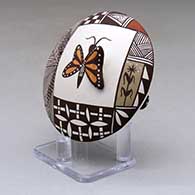 A polychrome seed pot decorated with butterfly wing and lady bug appliques and a butterfly, fineline, checkerboard and geometric design, click or tap to see a larger version