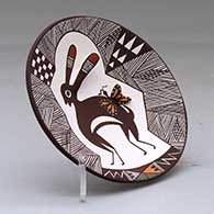 A polychrome plate decorated with rabbit ear and lady bug appliques and a Mimbres rabbit, butterfly, fineline and geometric design, click or tap to see a larger version