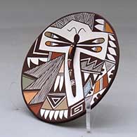 A polychrome plate decorated with dragonfly body and lady bug appliques and a dragonfly, fineline and geometric design, click or tap to see a larger version
