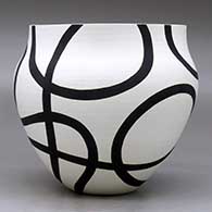 A black on white bowl decorated with a flowing geometric design, click or tap to see a larger version
