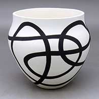 A black on white bowl decorated with a flowing geometric design
 by Eric Lewis of Acoma