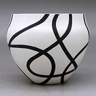 A black on white bowl decorated with a flowing geometric design, click or tap to see a larger version