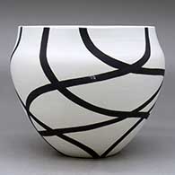 A black on white bowl decorated with a flowing geometric design, click or tap to see a larger version
