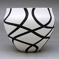 A black on white bowl decorated with a flowing geometric design, click or tap to see a larger version