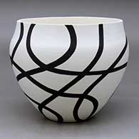 A black on white bowl decorated with a flowing geometric design
 by Eric Lewis of Acoma