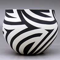 A black on white bowl decorated with a flowing four panel geometric design, click or tap to see a larger version