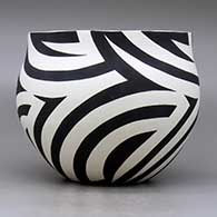 A black on white bowl decorated with a flowing four panel geometric design, click or tap to see a larger version