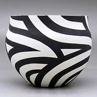 A black on white bowl decorated with a flowing four-panel geometric design, click or tap to see a larger version