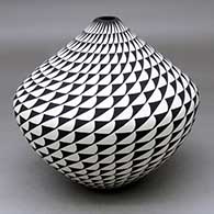 A black on white seed pot decorated with a spiral mesa geometric design
 by Cletus Victorino of Acoma