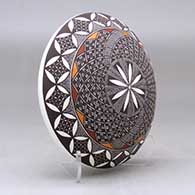 A polychrome seed pot decorated with a fineline, yucca leaf snowflake and geometric design above the shoulder, click or tap to see a larger version
