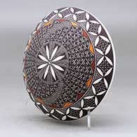 A polychrome seed pot decorated with a fineline, yucca leaf snowflake and geometric design above the shoulder, click or tap to see a larger version