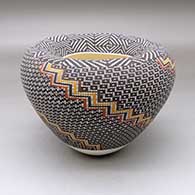 A polychrome jar with an Infinity rim and decorated with a geometric design built of tiny squares
 by Frederica Antonio of Acoma