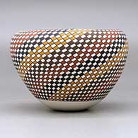 A polychrome jar with an Infinity rim and decorated with a spiral checkerboard geometric design, click or tap to see a larger version