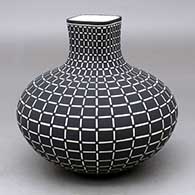 Click for a larger view A black on white jar with a short square neck decorated from top to bottom with a geometric design
by Paula Estevan of Acoma