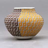 A small jar decorated with a four-panel geometric design built of tiny colored squares, click or tap to see a larger version