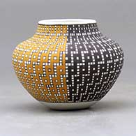 A small jar decorated with a four-panel geometric design built of tiny colored squares, click or tap to see a larger version