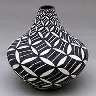 A black on white tear drop jar decorated with a pumpkin seed snowflake and geometric design
 by Sandra Victorino of Acoma