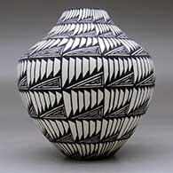 A black on white jar decorated with a geometric design, click or tap to see a larger version