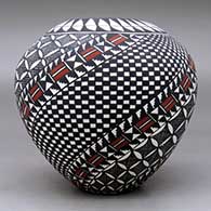 A polychrome jar decorated with a spiral checkerboard, pumpkin seed snowflake, fineline and geometric design, click or tap to see a larger version