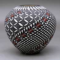 A polychrome jar decorated with a spiral checkerboard, pumpkin seed snowflake, fineline and geometric design, click or tap to see a larger version