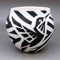 A black on white jar decorated with a hummingbird and ribbon geometric design
 by Eric Lewis of Acoma