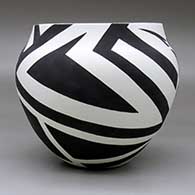 A black on white jar decorated with a hummingbird and geometric design, click or tap to see a larger version