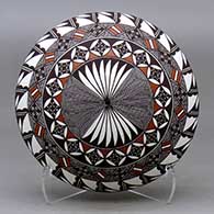 A polychrome seed pot decorated above the shoulder with a fineline, yucca leaf snowflake and geometric design
 by Rebecca Lucario of Acoma