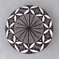 A black on white seed pot decorated above the shoulder with a fineline, yucca leaf snowflake and geometric design
 by Amanda Lucario of Acoma