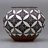 A small polychrome jar decorated around the body with a fineline, basket weave, yucca leaf snowflake and geometric design, click or tap to see a larger version