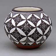 A small polychrome jar decorated around the body with a fineline, basket weave, yucca leaf snowflake and geometric design
 by Amanda Lucario of Acoma