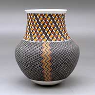 A polychrome jar with a recurved neck and decorated with a four panel tiny square geometric design below the neck and a 3D geometric design around the neck, click or tap to see a larger version