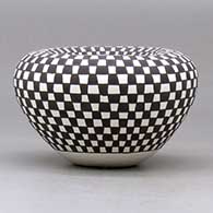 A small bowl with an Infinity rim and decorated with a checkerboard design, click or tap to see a larger version