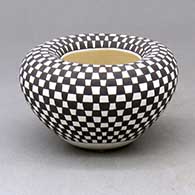 A small bowl with an Infinity rim and decorated with a checkerboard design
 by Frederica Antonio of Acoma
