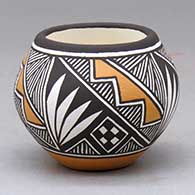 A small polychrome jar decorated with a four panel fineline and geometric design
 by Marilyn Ray of Acoma