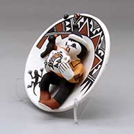 A small polychrome plate with boy, canteen, bird and lady bug appliques and decorated with a geometric design, click or tap to see a larger version