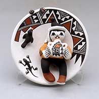 A small polychrome plate with boy, canteen, bird and lady bug appliques and decorated with a geometric design
 by Marilyn Ray of Acoma