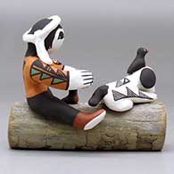 A boy with a puppy, a couple birds and a lady bug sitting on a log together, click or tap to see a larger version